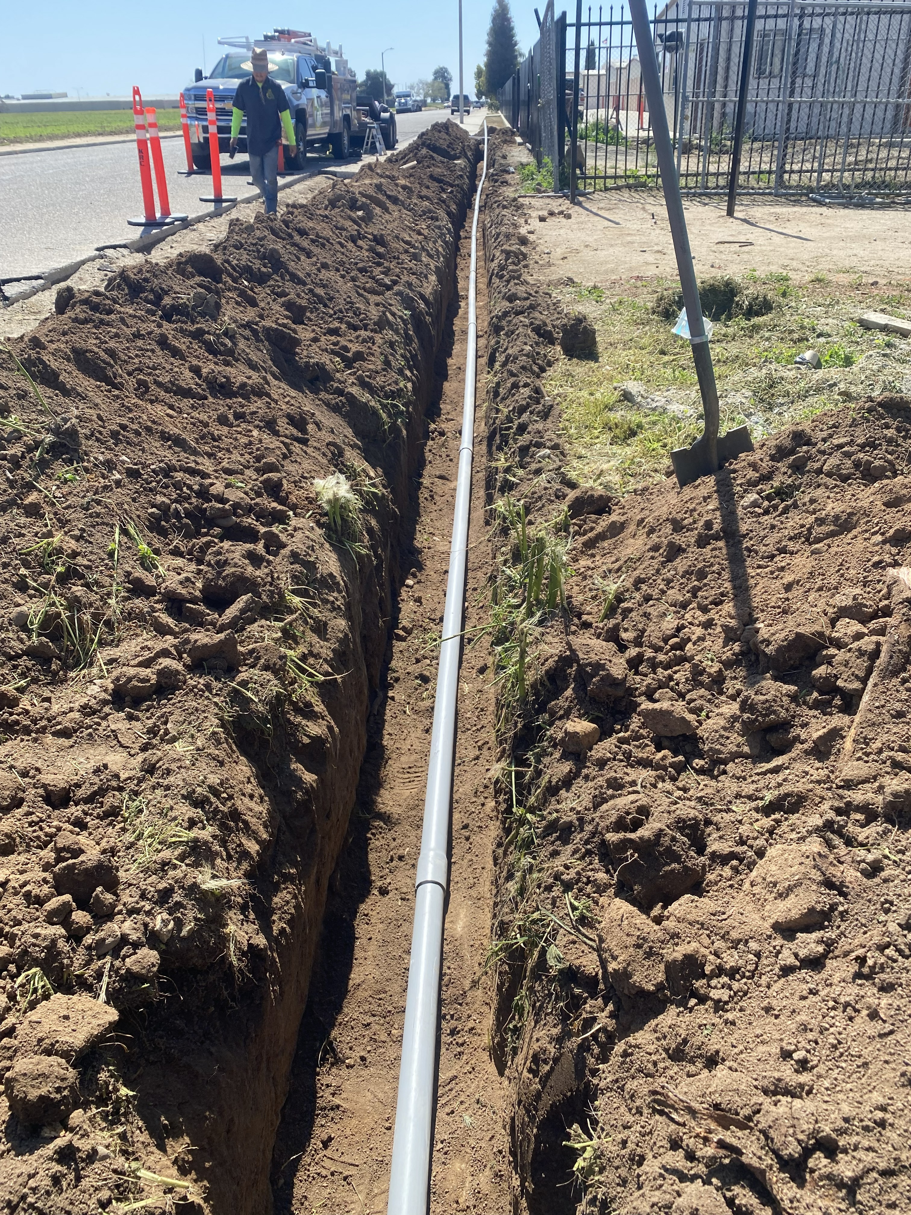 Commercial electrician installing underground conduit for commercial property maintenance in Visalia, CA.